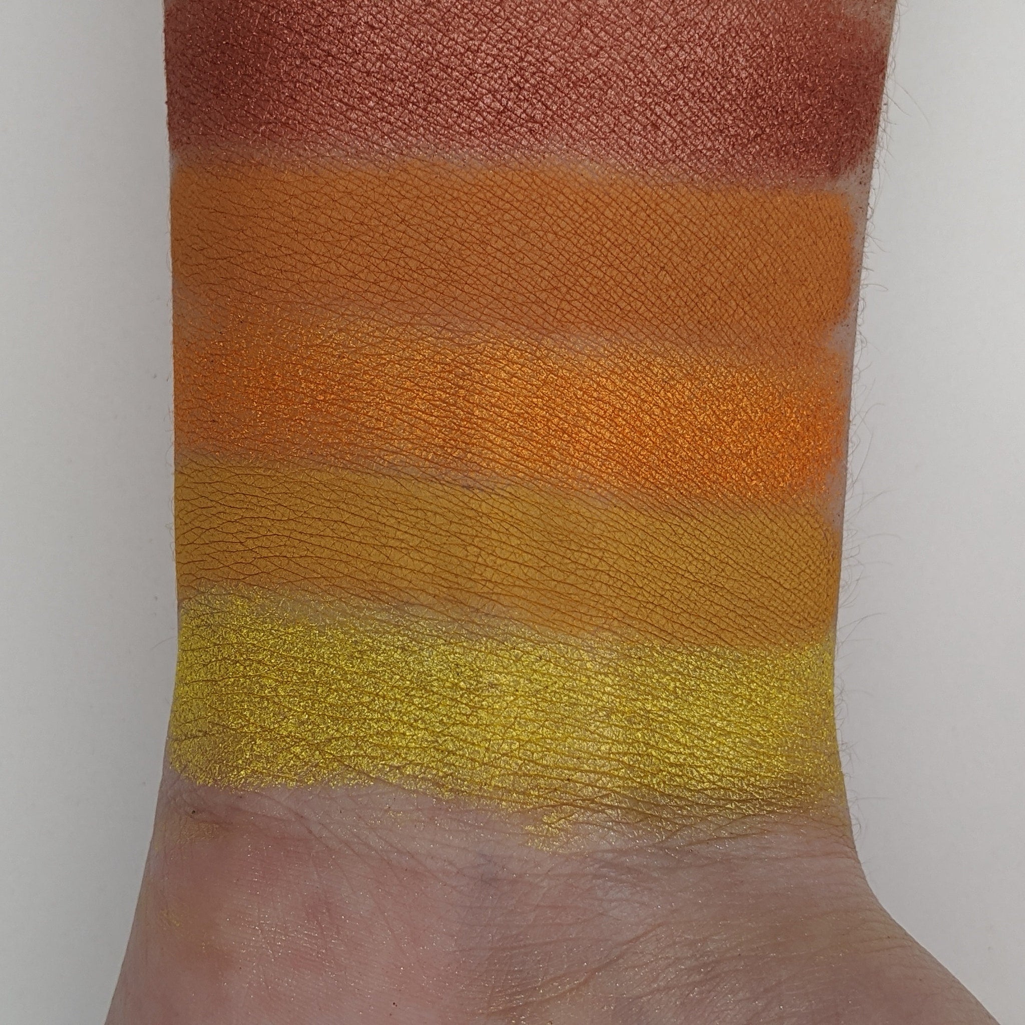 Autumn Splendor eyeshadow palette open to reveal warm yellow, orange, red, green, and brown matte shades in rectangular pans.