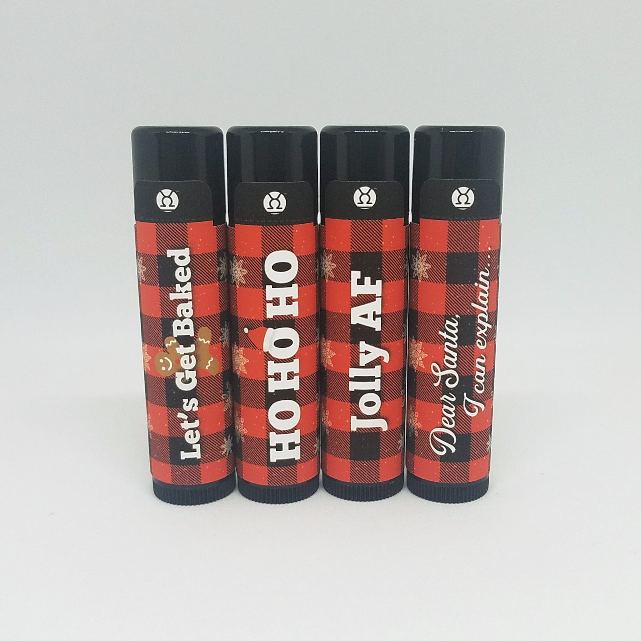 Lip balm tubes with red and black plaid pattern, black caps, and text labels with Venus Complete logo