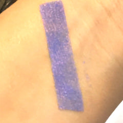 Close-up of shimmery purple and blue mineral eyeshadow with vegan mica pigments in compact pan