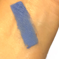 Close-up of matte cornflower blue and periwinkle eye shadow duo with smooth pressed powder texture