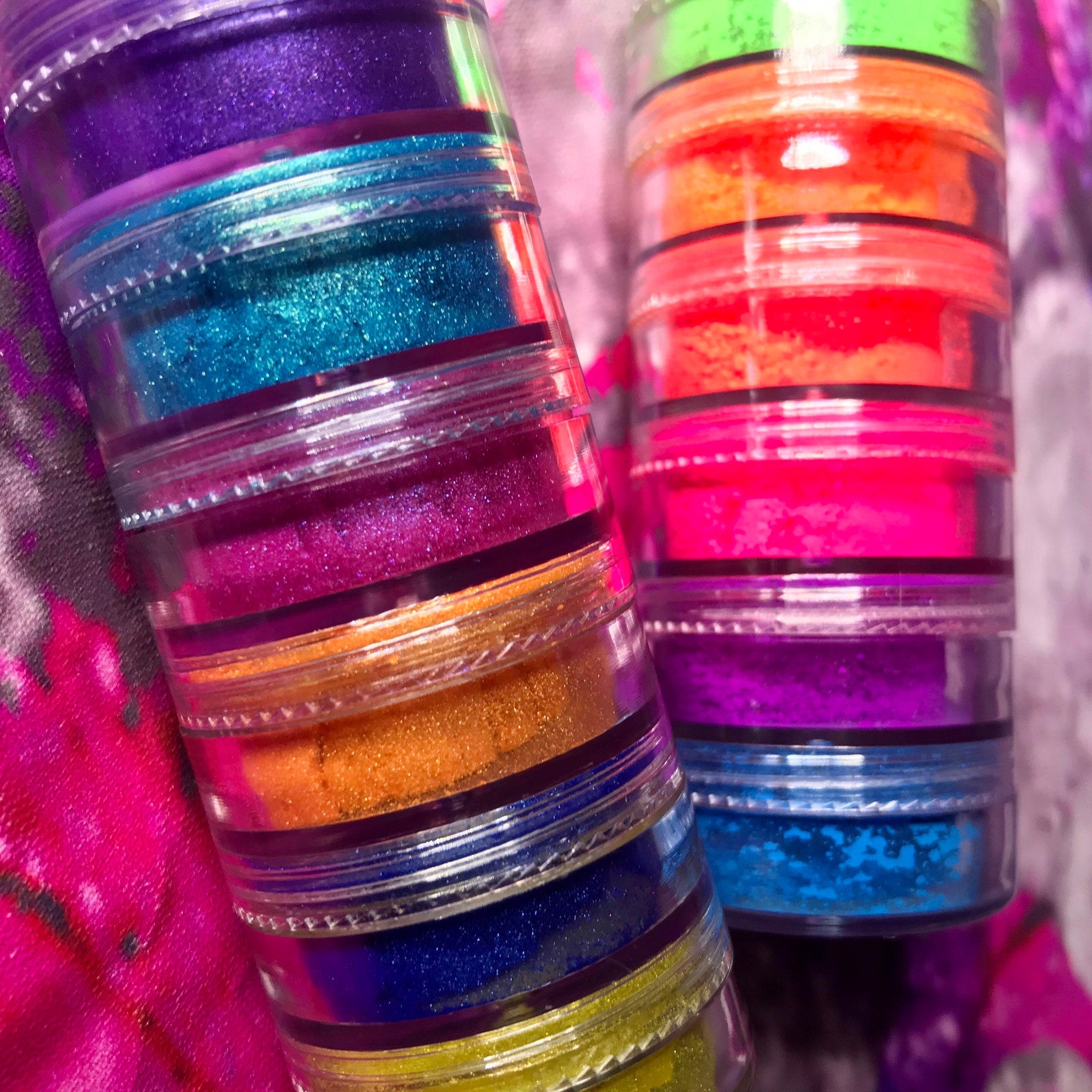 Side view of vegan mineral eyeshadow set showing 6 matte and 6 shimmery stacks in vibrant rainbow colors