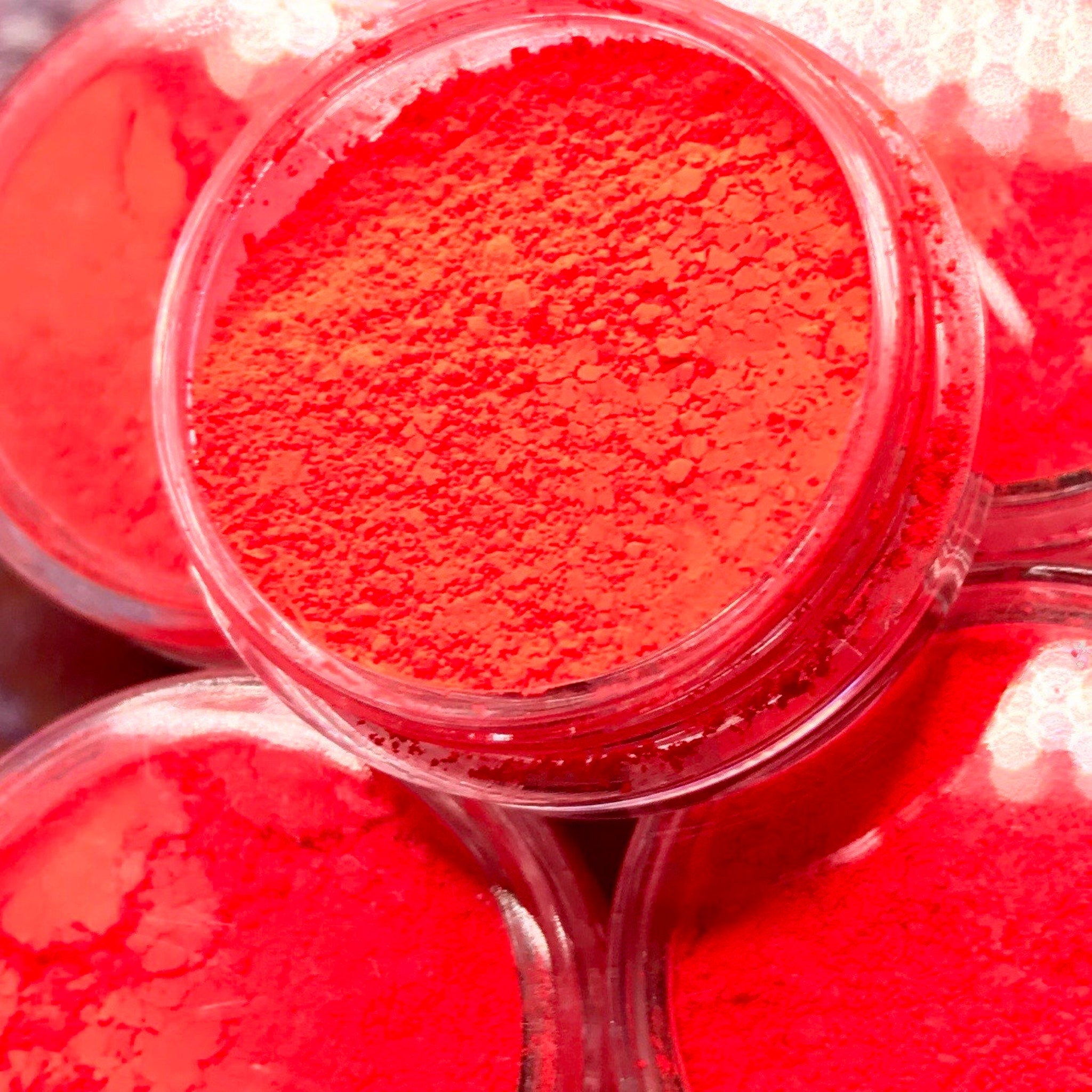 Vibrant red eyeshadow pigment with ultra-blendable texture shown in bonus travel-size compact