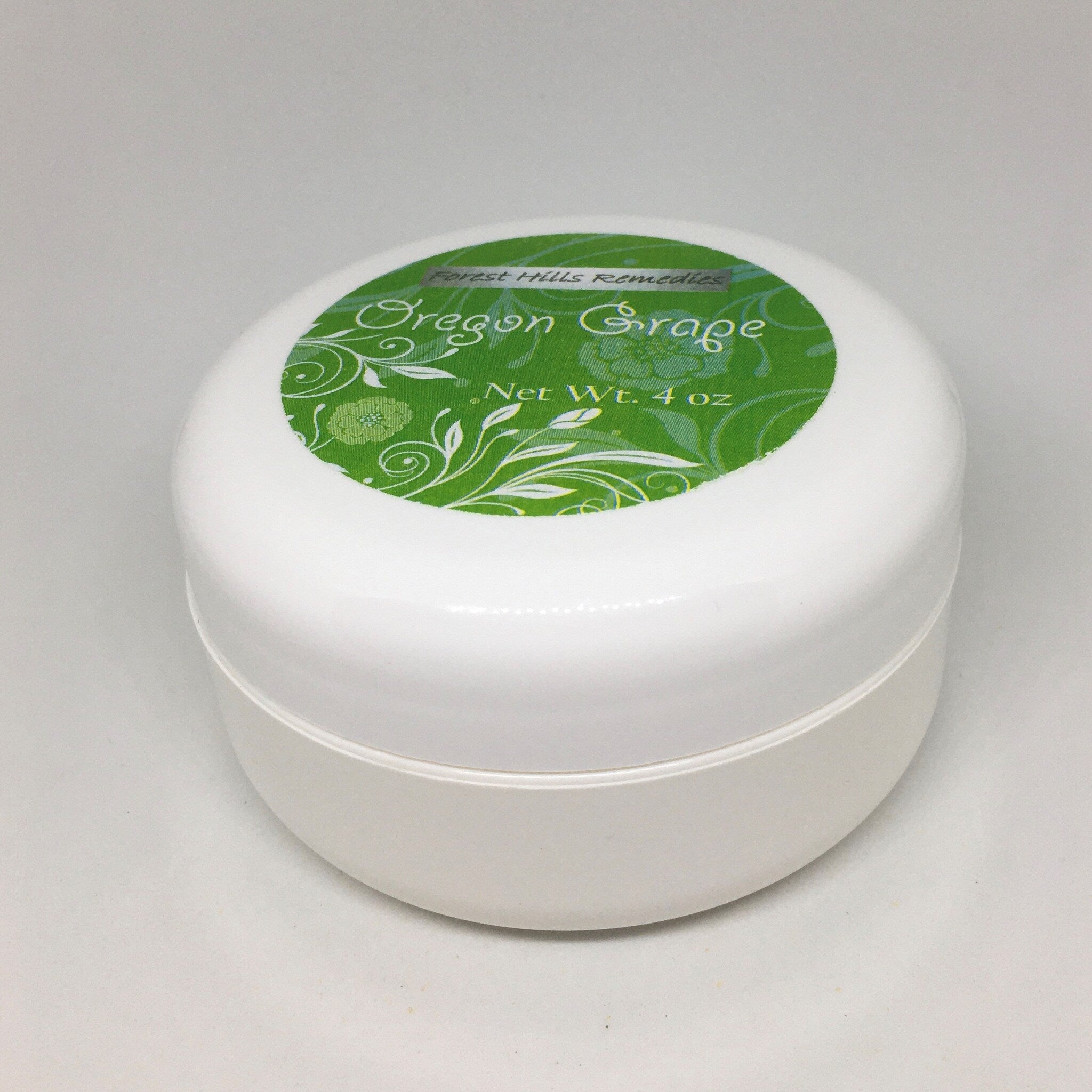 Eco-friendly amber glass jar of Oregon Grape Cream with minimalist gold label and creamy texture visible