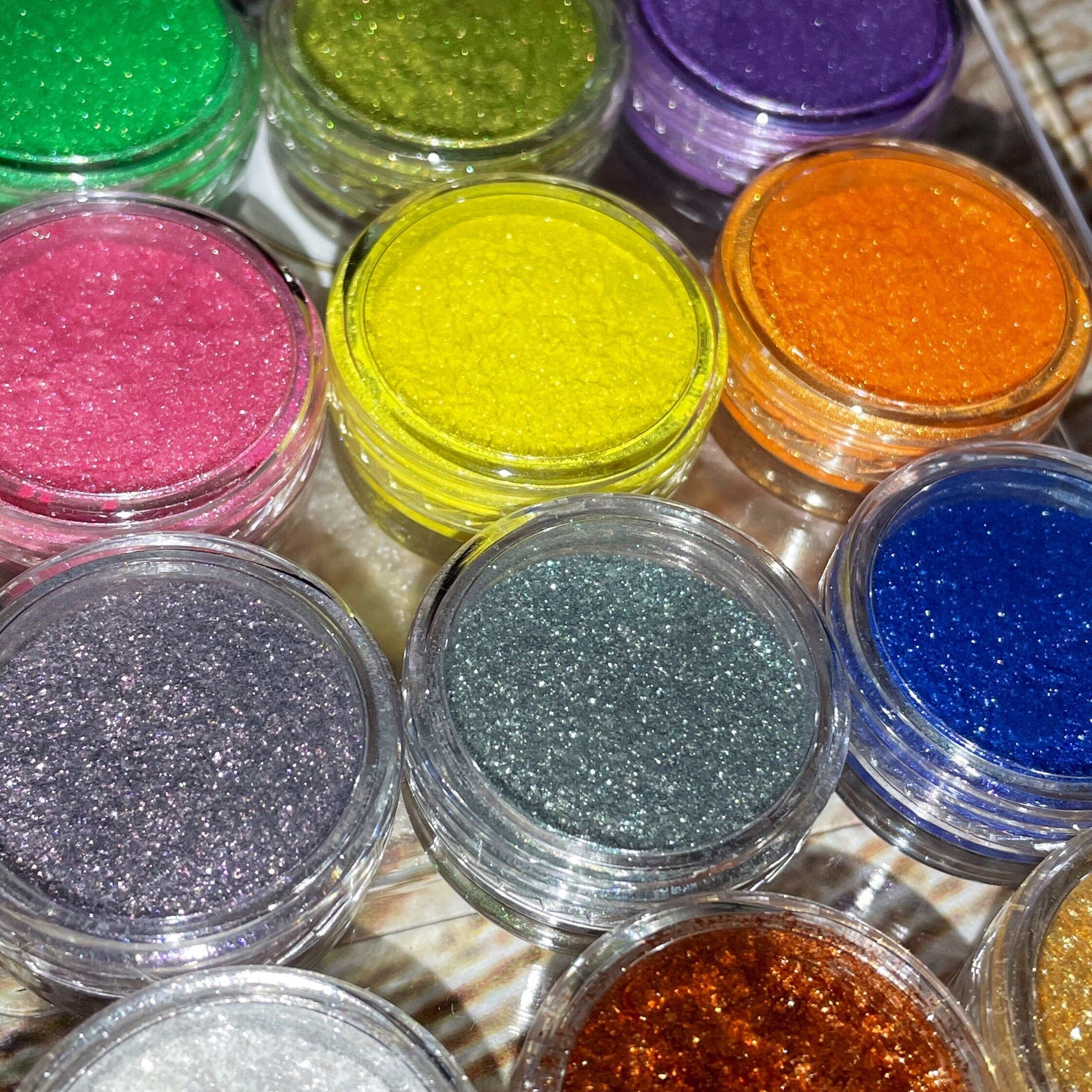 Close-up of shimmery vegan eyeshadow palette showing 12 vibrant shades with high pigmentation for bold looks