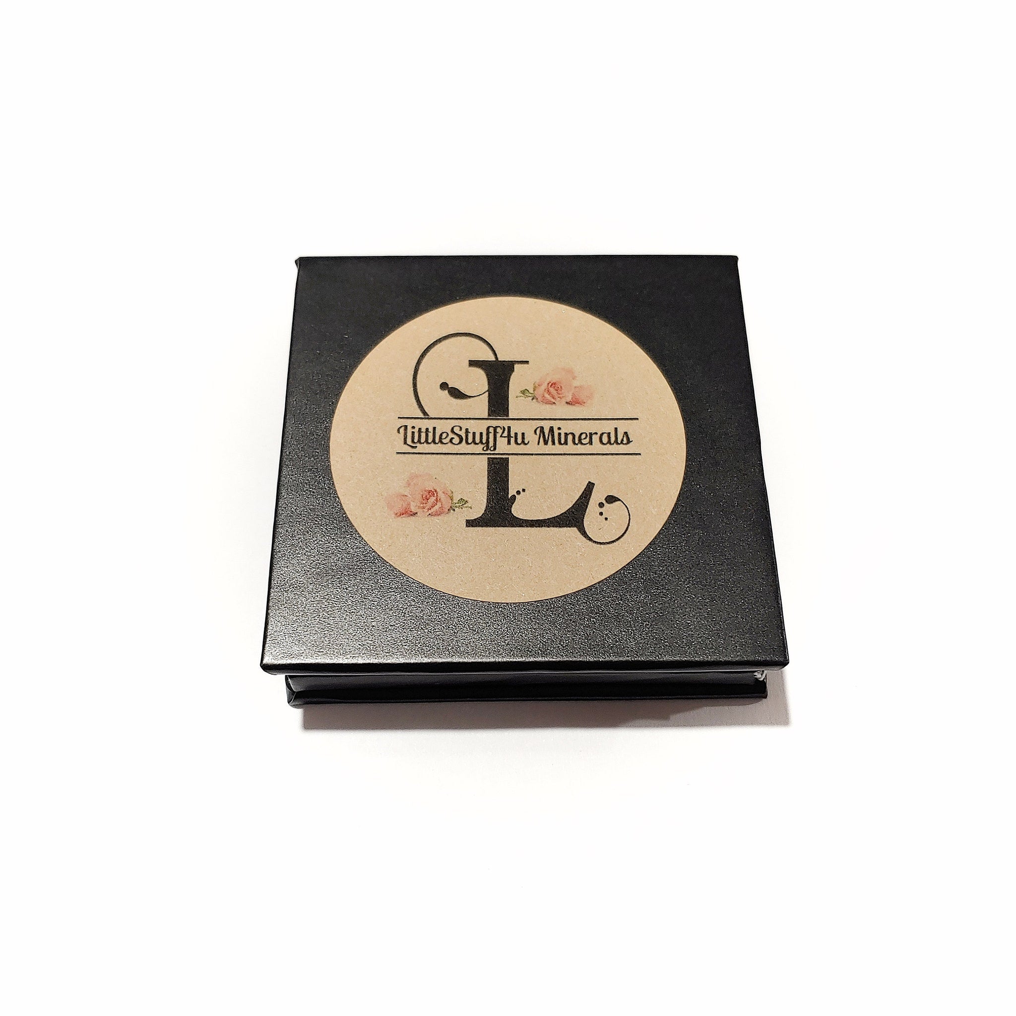 Side view of platinum silver mineral eye shadow compact showing reflective metallic finish and smooth texture