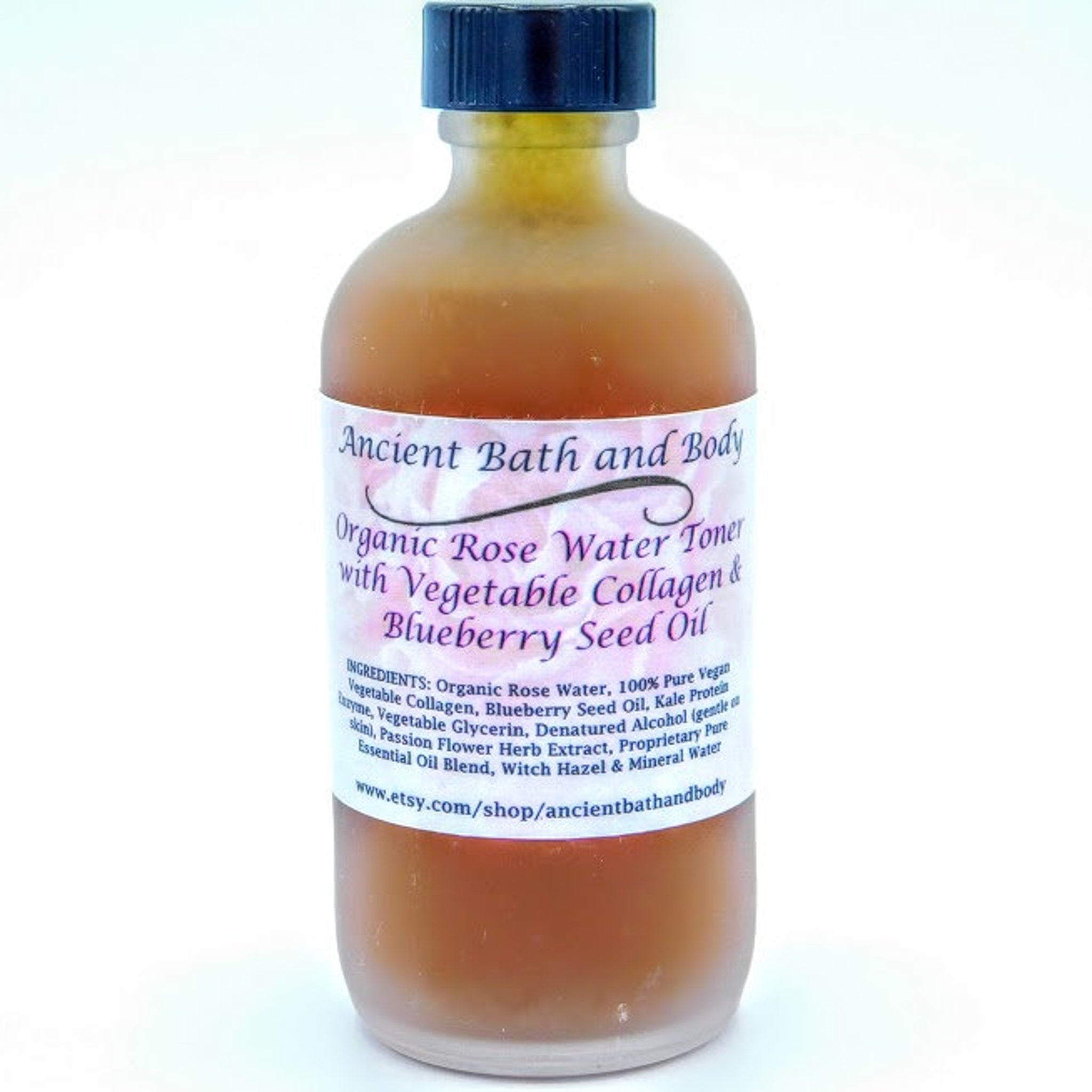 Rose water toner bottle with brown liquid, black cap, and white label with text