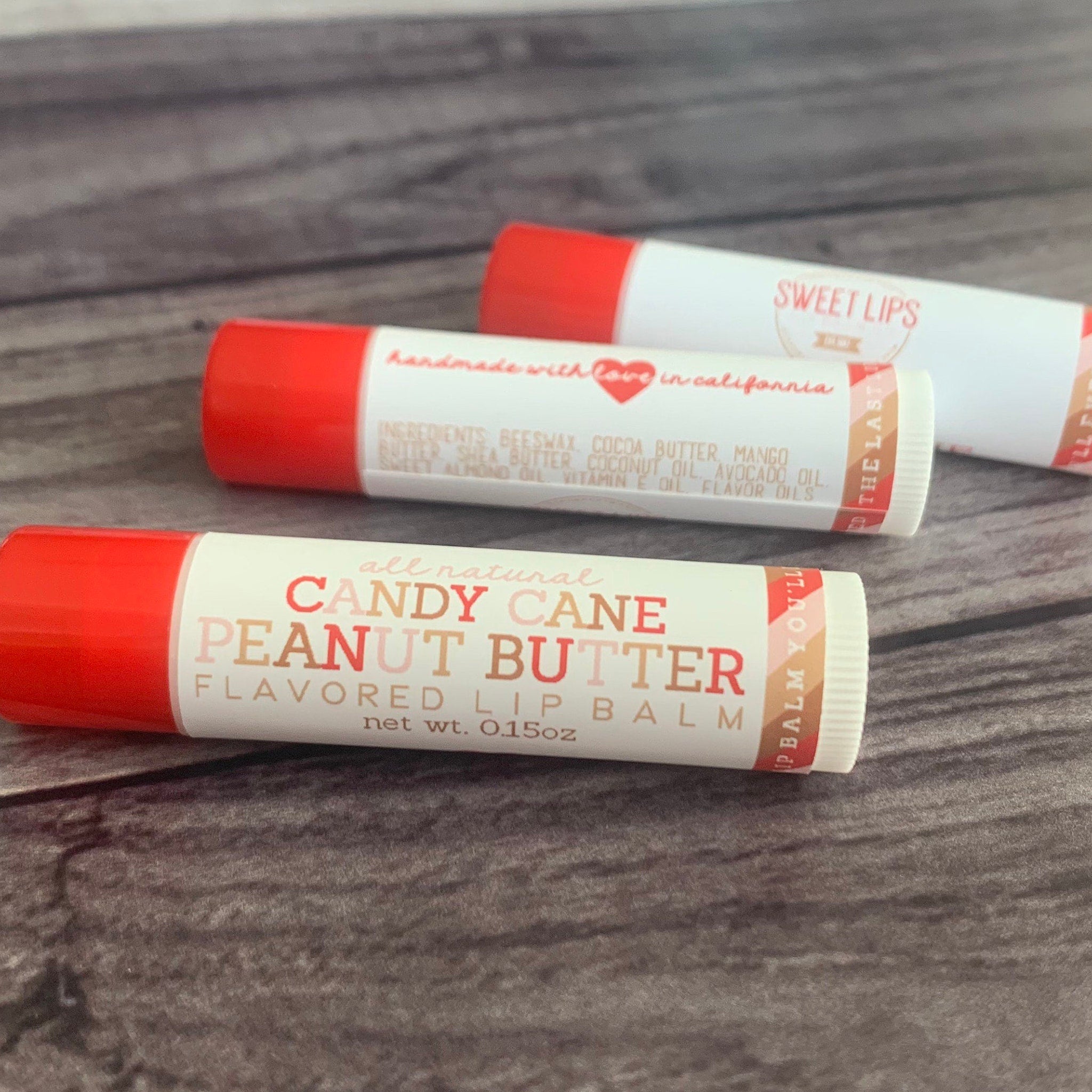Lip balm tubes with red caps and white labels, Candy Cane Peanut Butter flavor, Sweet Lips brand