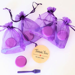 Purple organza gift bags with purple lids and scoops, "Thank You" tag for order.
