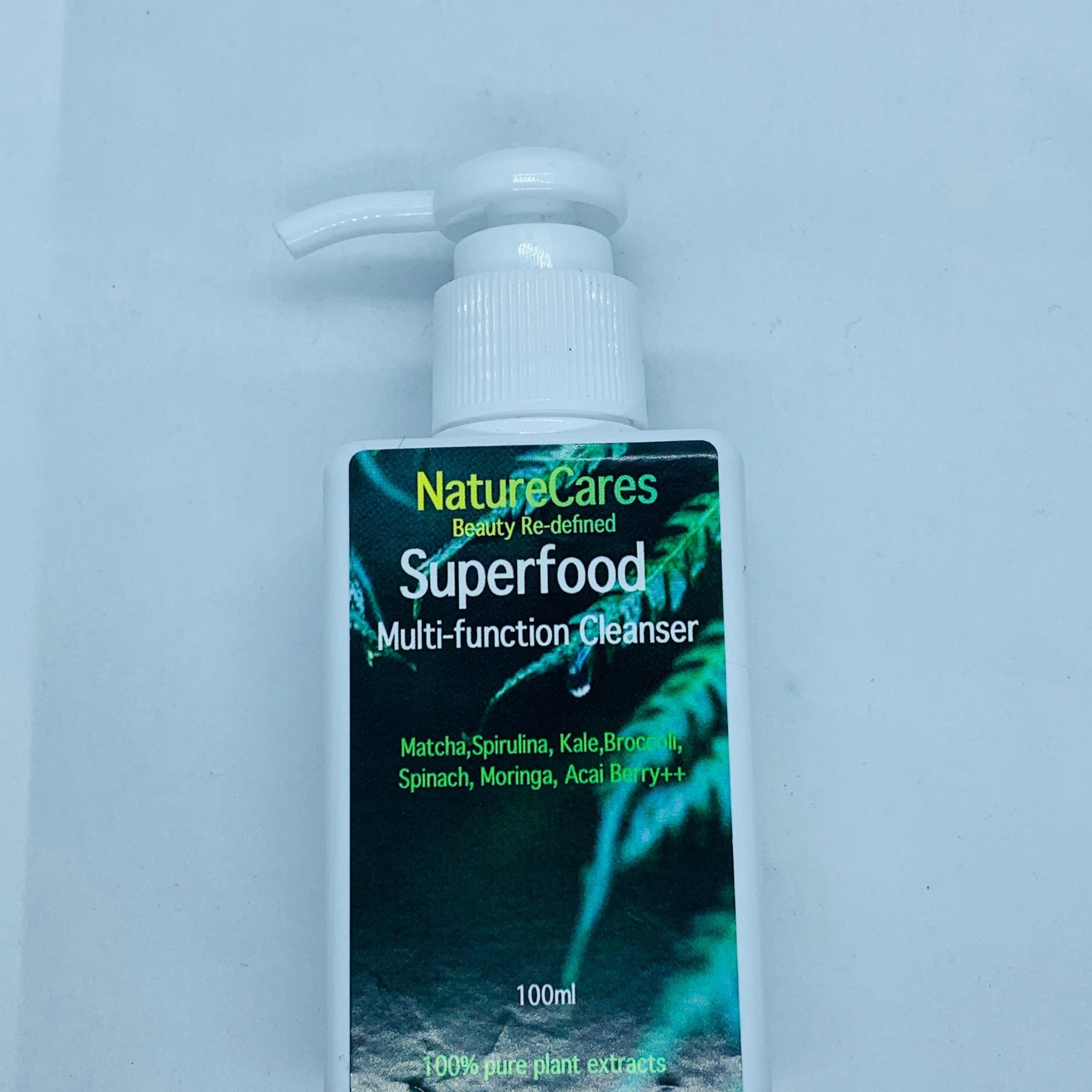 Cleanser bottle, white plastic pump, green and white label with "Superfood" text, NatureCares brand