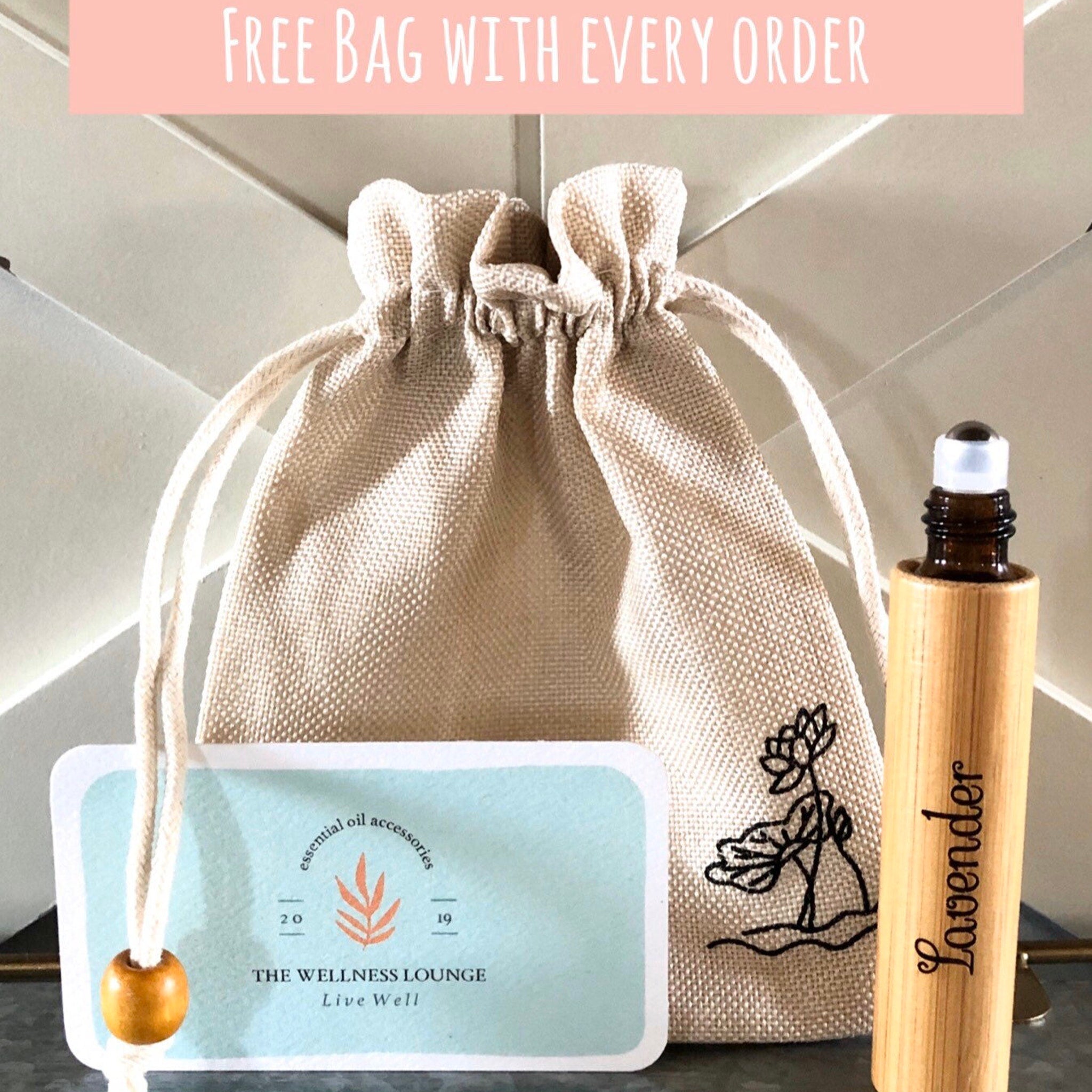 Canvas drawstring bag with wooden essential oil roller and "Lavender" text