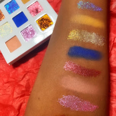 Close-up of holiday eyeshadow palette showing glitter gold and matte burgundy shades with smooth textures