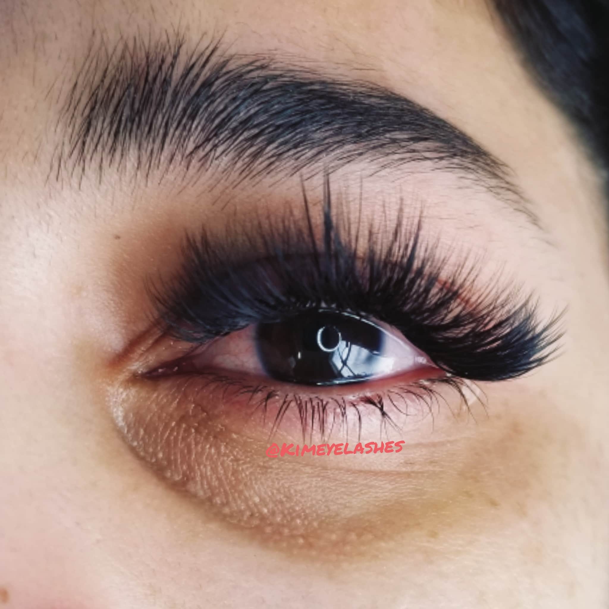 Eyelash extensions with black, layered, fluffy style, Kimeyelashes brand visible