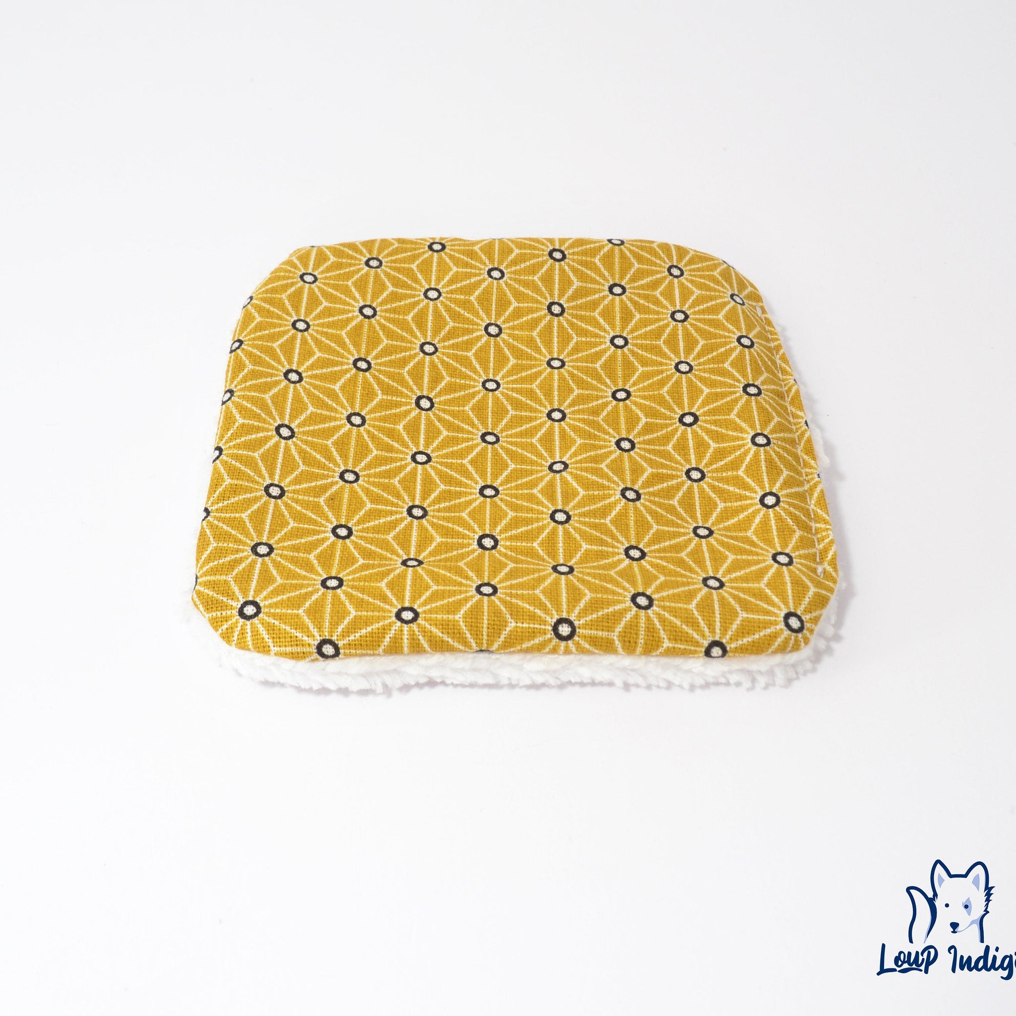 Yellow geometric patterned fabric with white trim, Loup Indigo logo visible