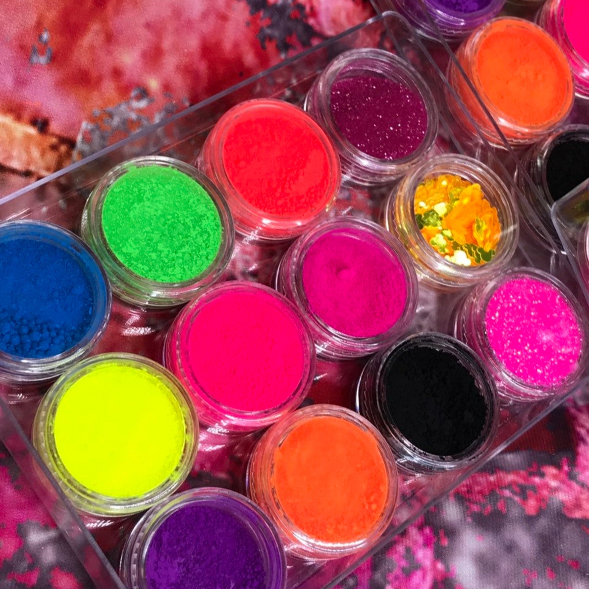 Side view of vegan neon eyeshadow palette showing vibrant matte shades in pink, yellow, and green