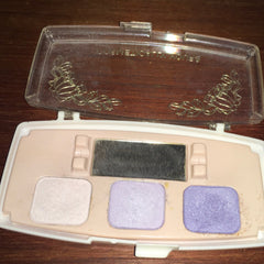 Close-up of Cosmetically Yours Eye Shadow Palette showing shimmering bronze and matte taupe shades with smooth powder texture