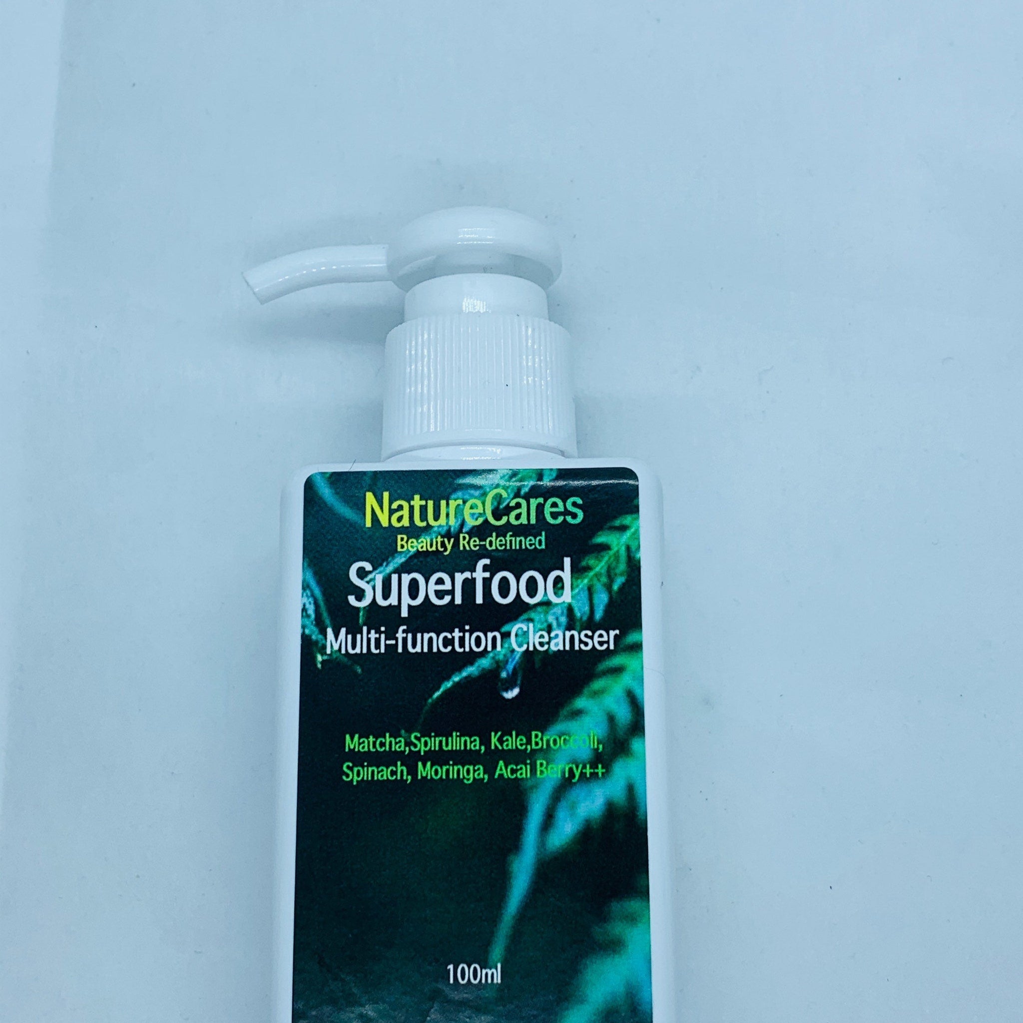 Multi-function cleanser bottle with white pump, green and black label, NatureCares Superfood text