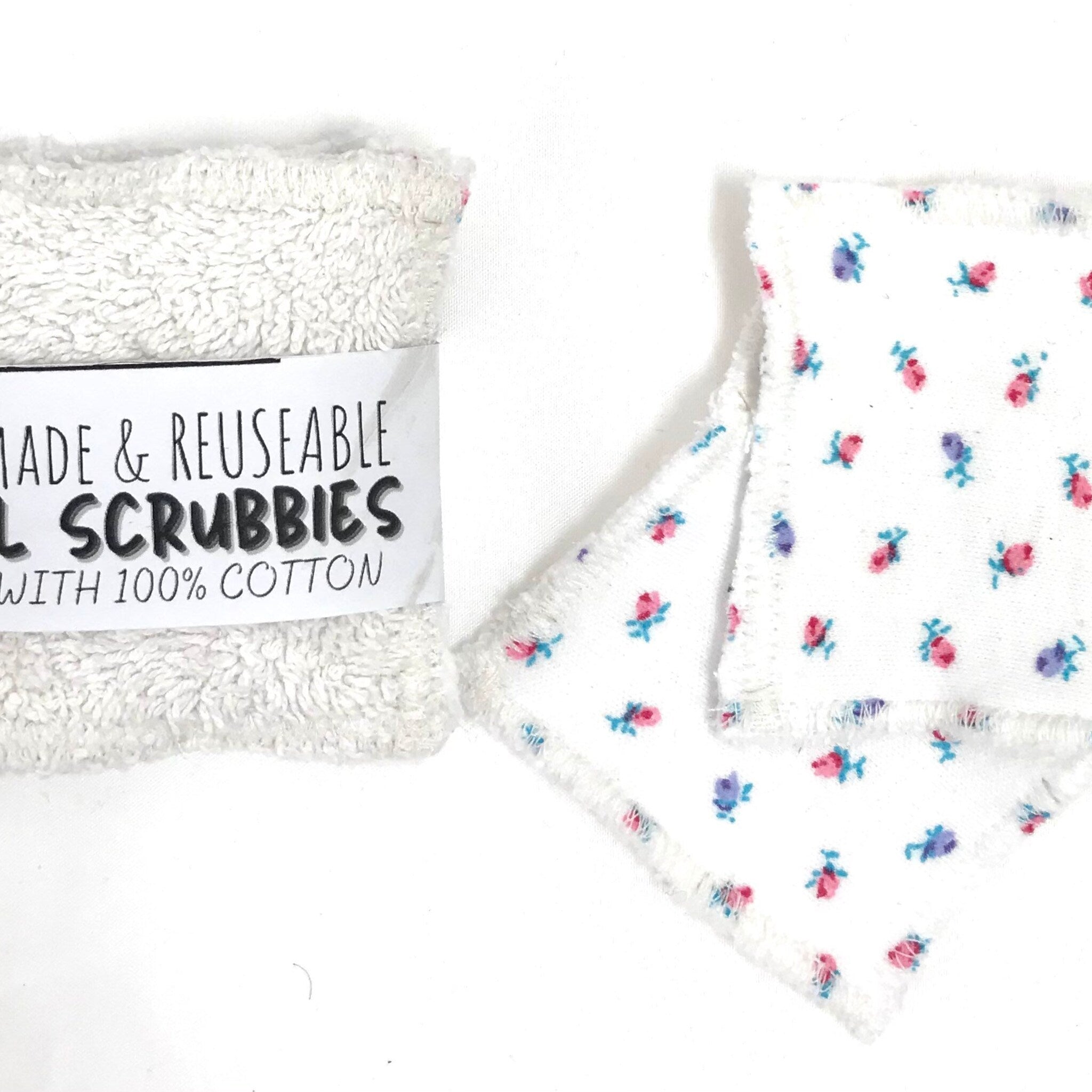 Reusable scrubbies, white terry cloth and floral print, with "SCRUBBIES" text visible