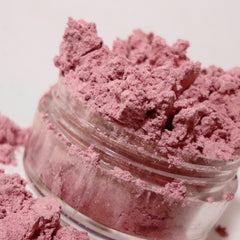 Close-up of pale pink shimmer mineral eyeshadow with luster finish in compact case