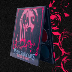 Side view of Divine Tragedy eyeshadow palette showing gothic shades in matte black, deep burgundy, and shimmering silver.