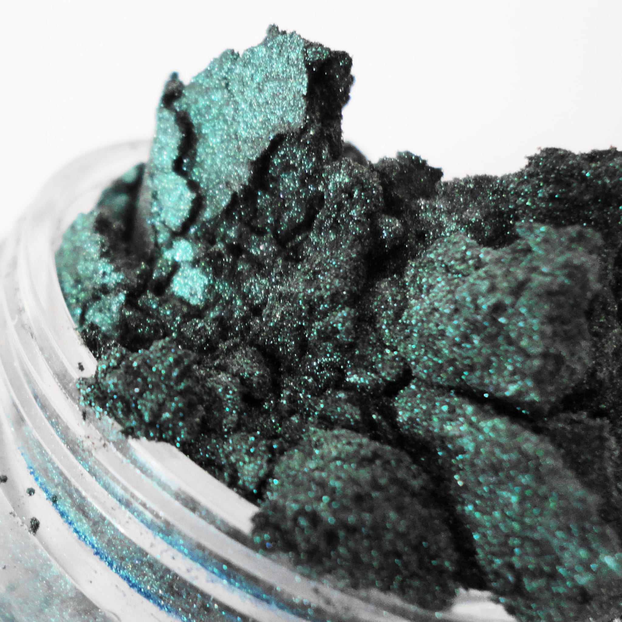 Mineral eyeshadow, emerald green, sparkly, crushed texture in a jar