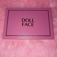 Close-up of Dollface Nudie Boudoir palette showing 12 matte and shimmer nude eye shadows in round pans with velvet case