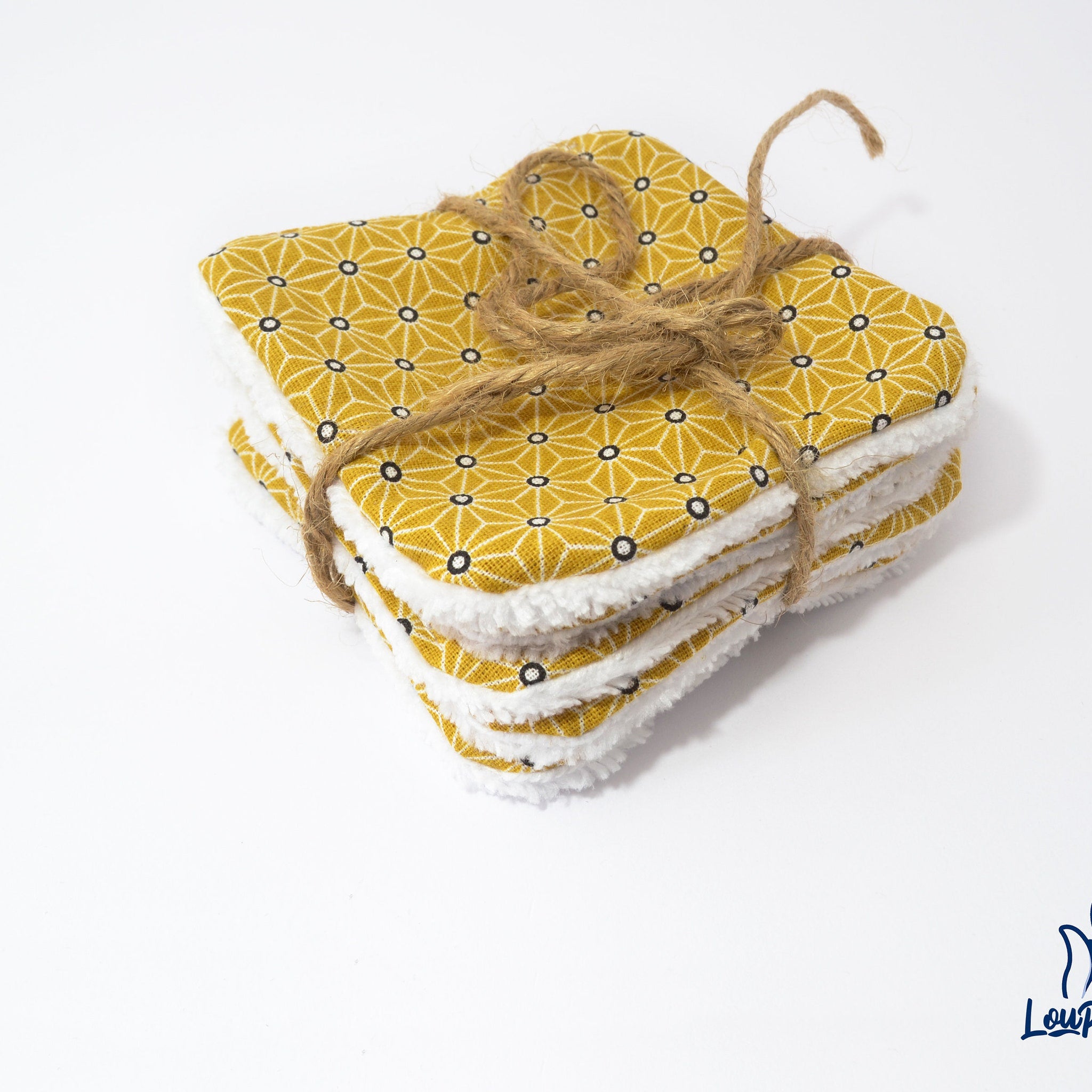 Makeup remover wipes, yellow geometric pattern, white trim, tied with twine