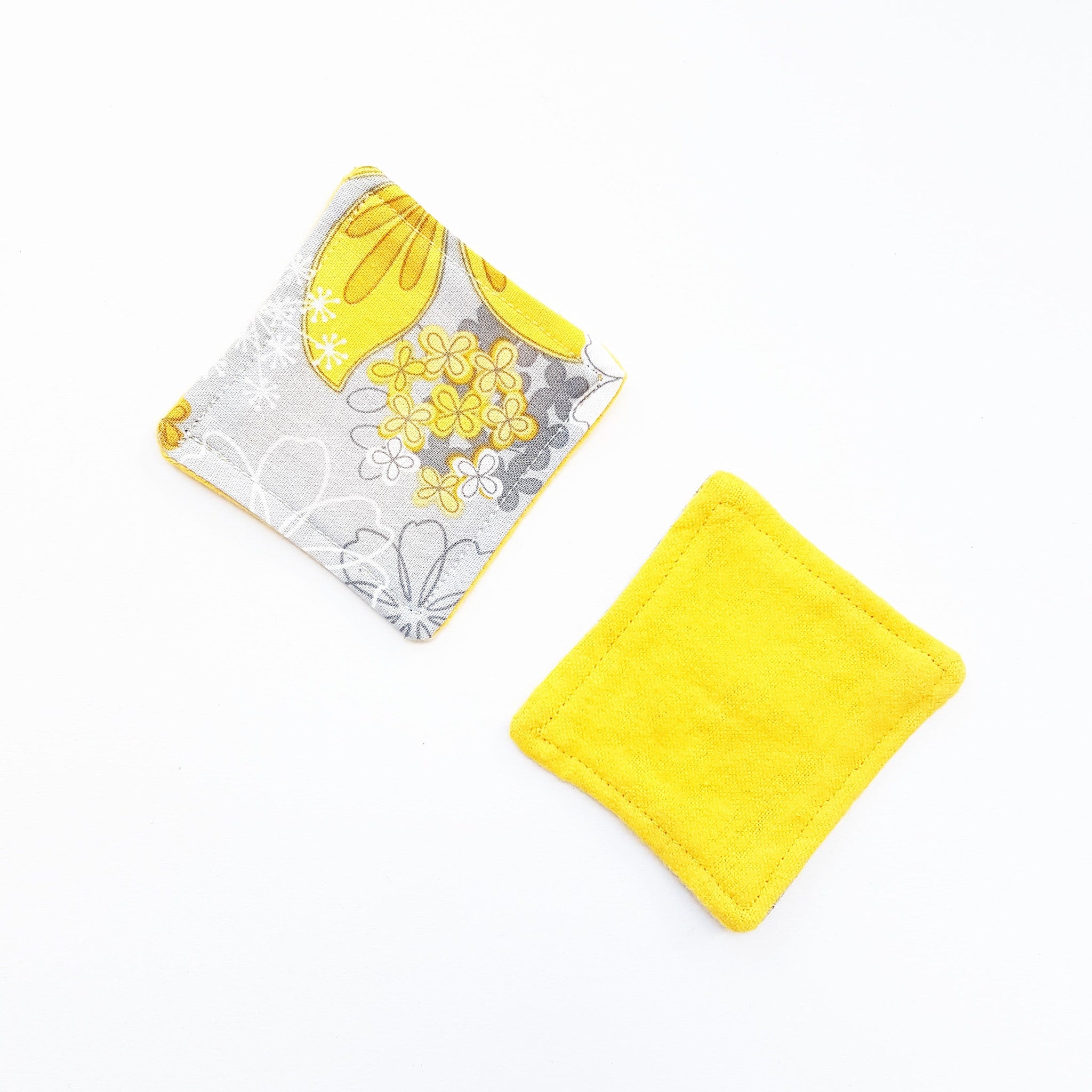 Square fabric coasters, yellow and floral pattern on gray, solid yellow textured coaster