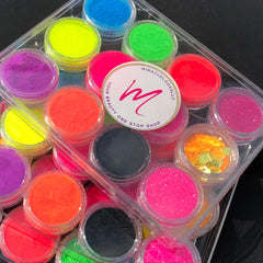 Side view of vegan neon eyeshadow palette showing vibrant matte shades in pink, yellow, and blue