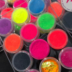 Close-up of vibrant neon pink and yellow matte eyeshadow pans with smooth pigment texture