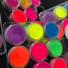 Side view of vegan neon eyeshadow palette showing vibrant matte shades in pink, yellow, and blue