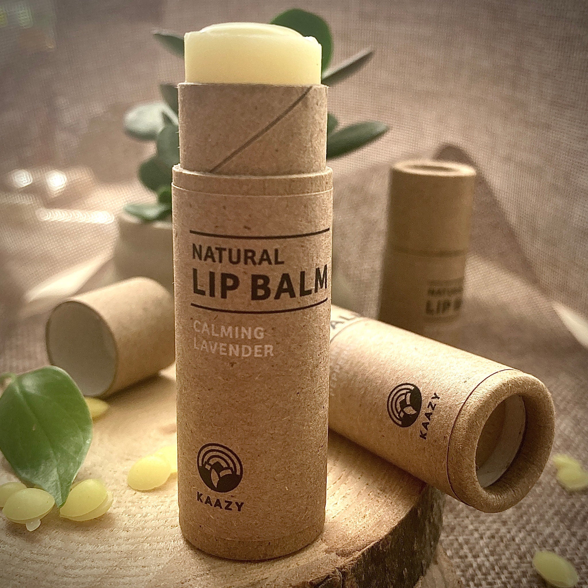 Lip balm in brown cardboard tube with yellow balm and KAAZY branding