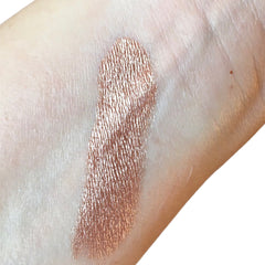 Swatched eyeshadow, metallic bronze color with textured finish on skin