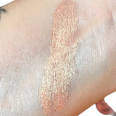 Close-up of shimmering peach eyeshadow with glitter flecks in a round 10g jar