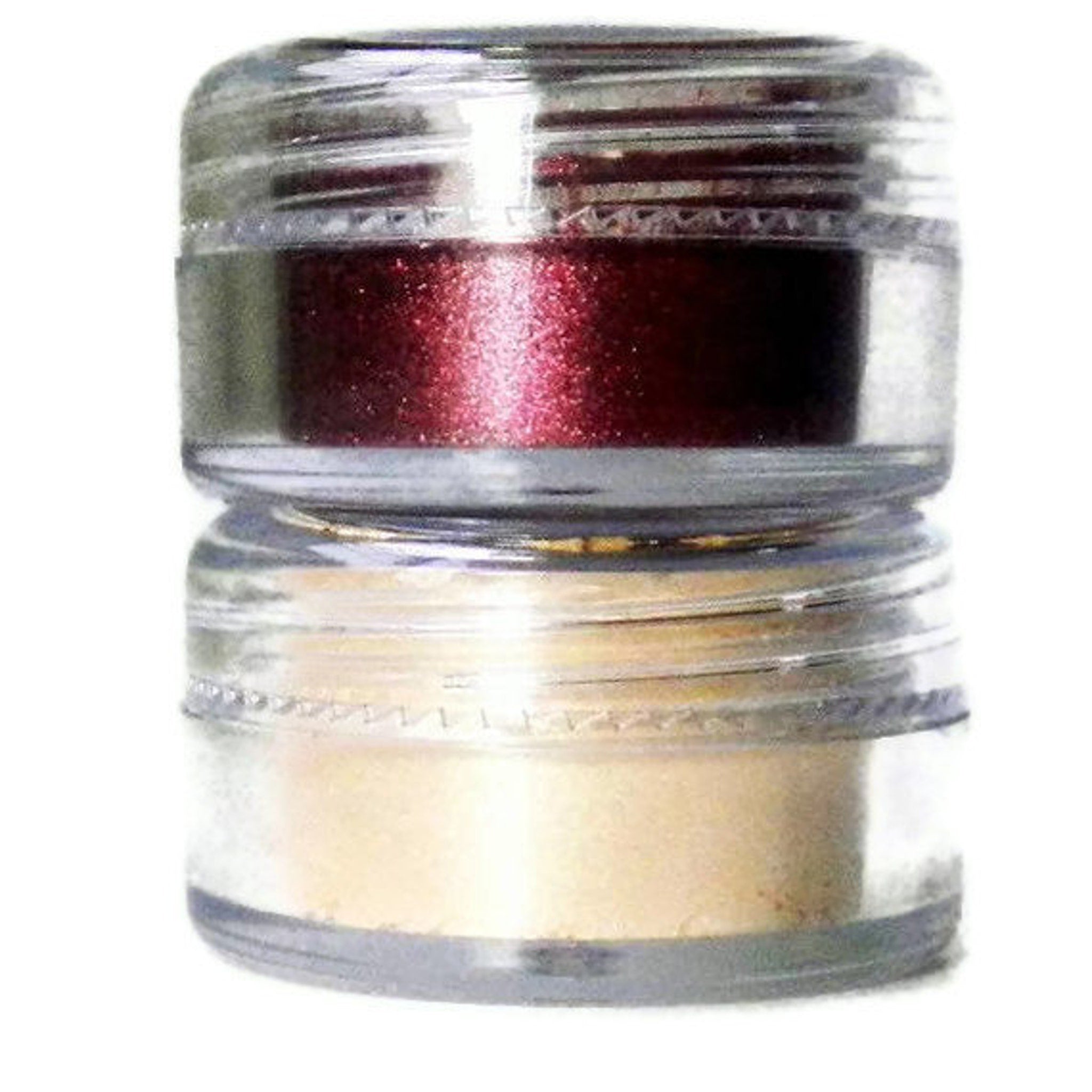 Eyeshadow set with clear glass jars, red and beige powders, stacked design