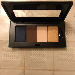 Mary Kay mini eyeshadow palette with four matte and shimmer shades in neutral tones, compact black case