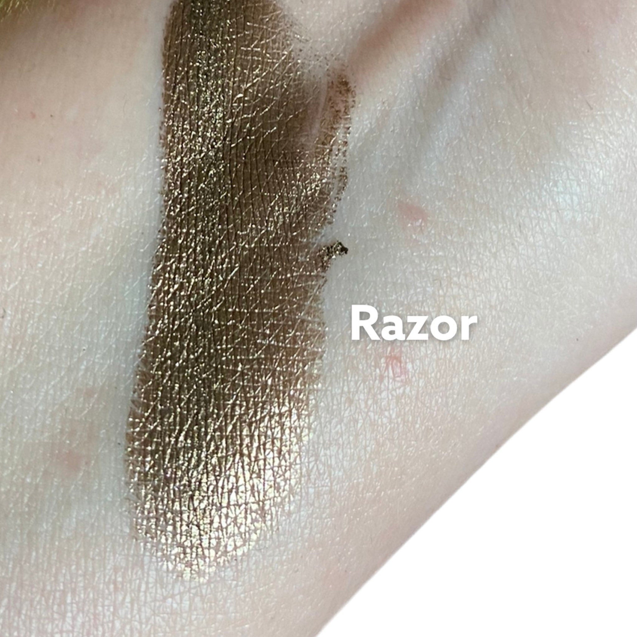 Close-up of dark brown metallic eyeshadow pan with shimmering mineral finish