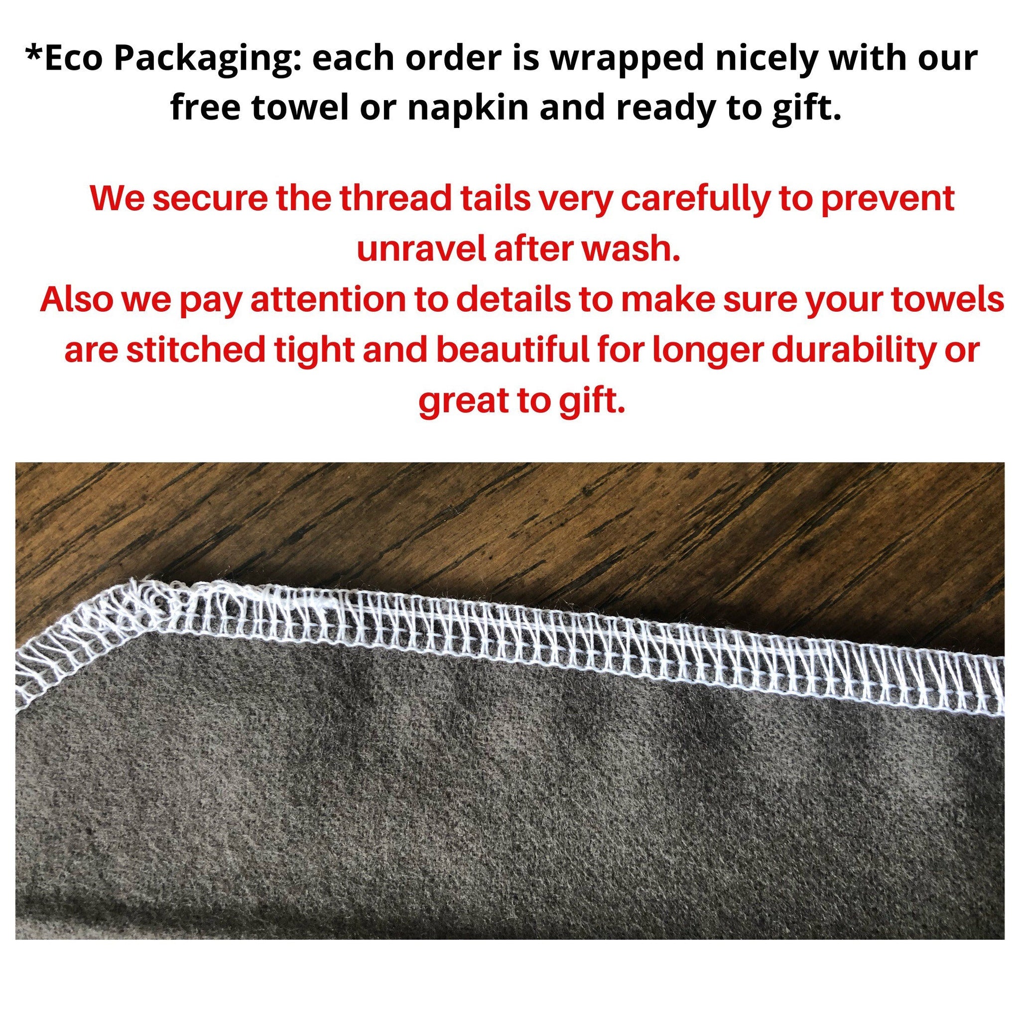 Gray fabric with white stitching detail, close-up view of towel edge