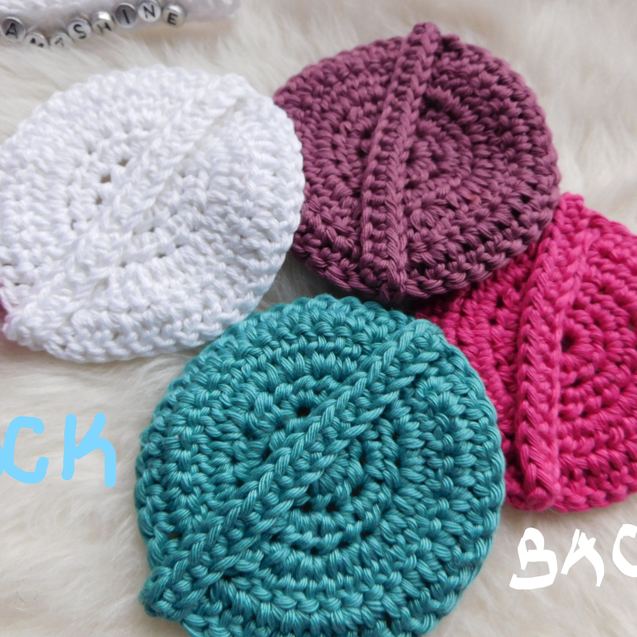 Crochet coasters in white, teal, pink, and purple, with visible stitch pattern and texture