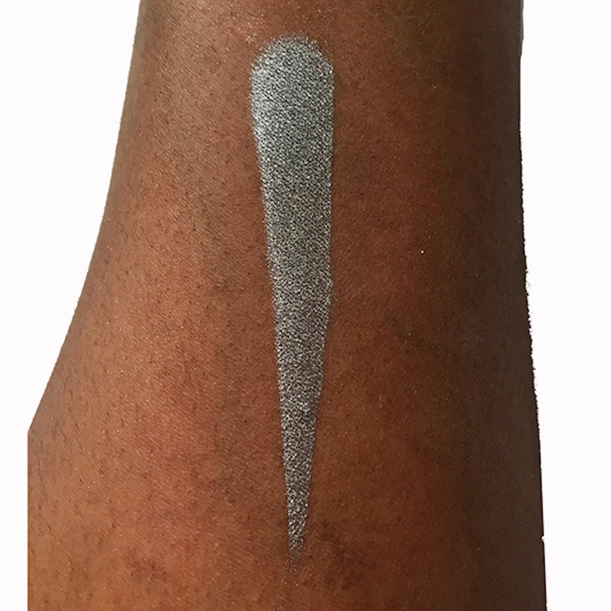 Eyeshadow swatch, silver shimmer, applied on arm, showing color and texture