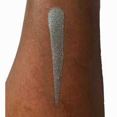 Eyeshadow swatch, silver shimmer, applied on arm, showing color and texture