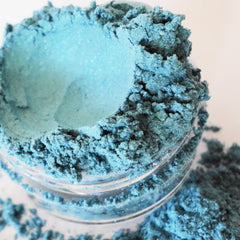 Eyeshadow powder, sky blue shimmer, in a clear jar with loose powder visible