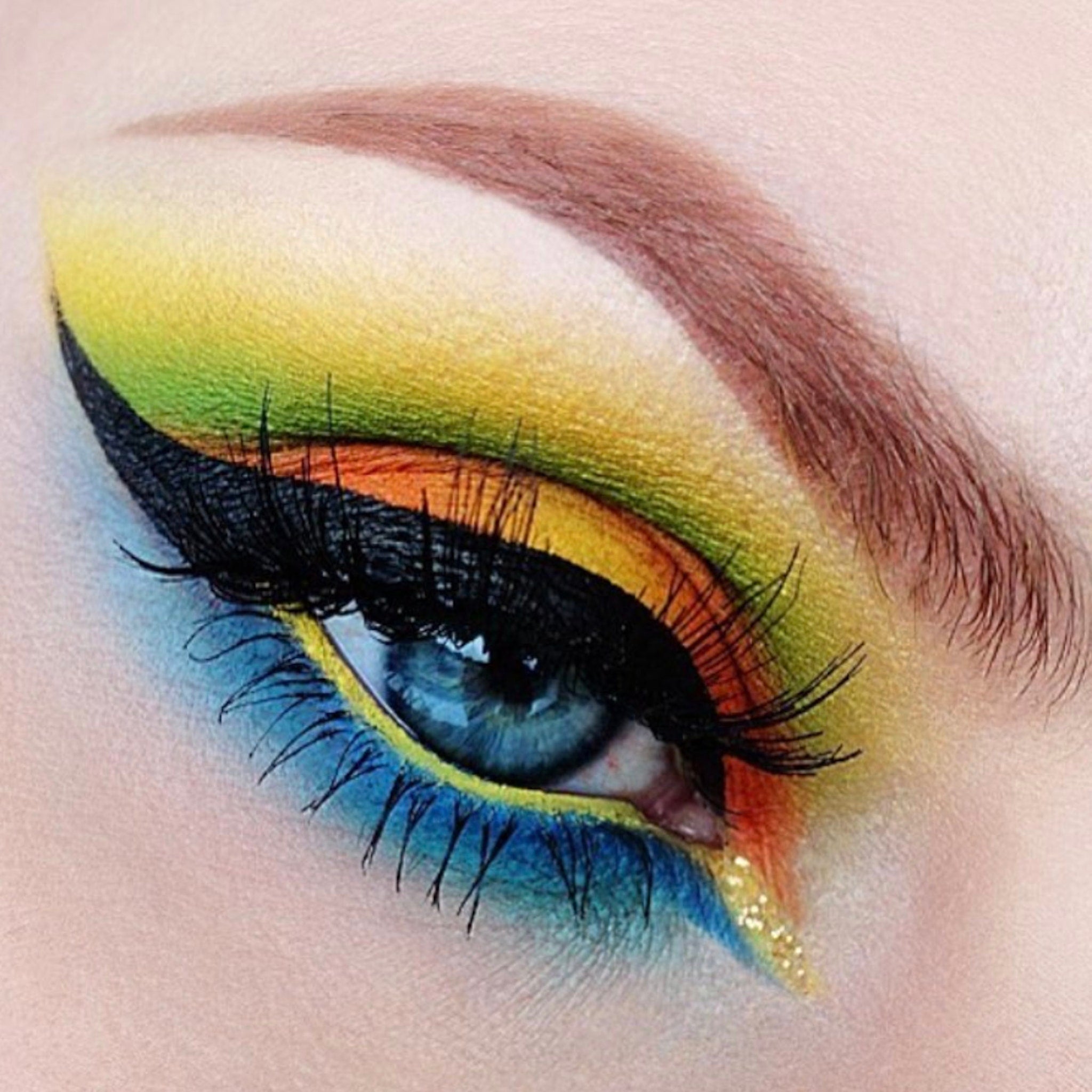 Eye makeup with colorful eyeshadow, black eyeliner, and long eyelashes for a vibrant look
