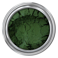 Green powder in silver metal container, cracked texture, top view