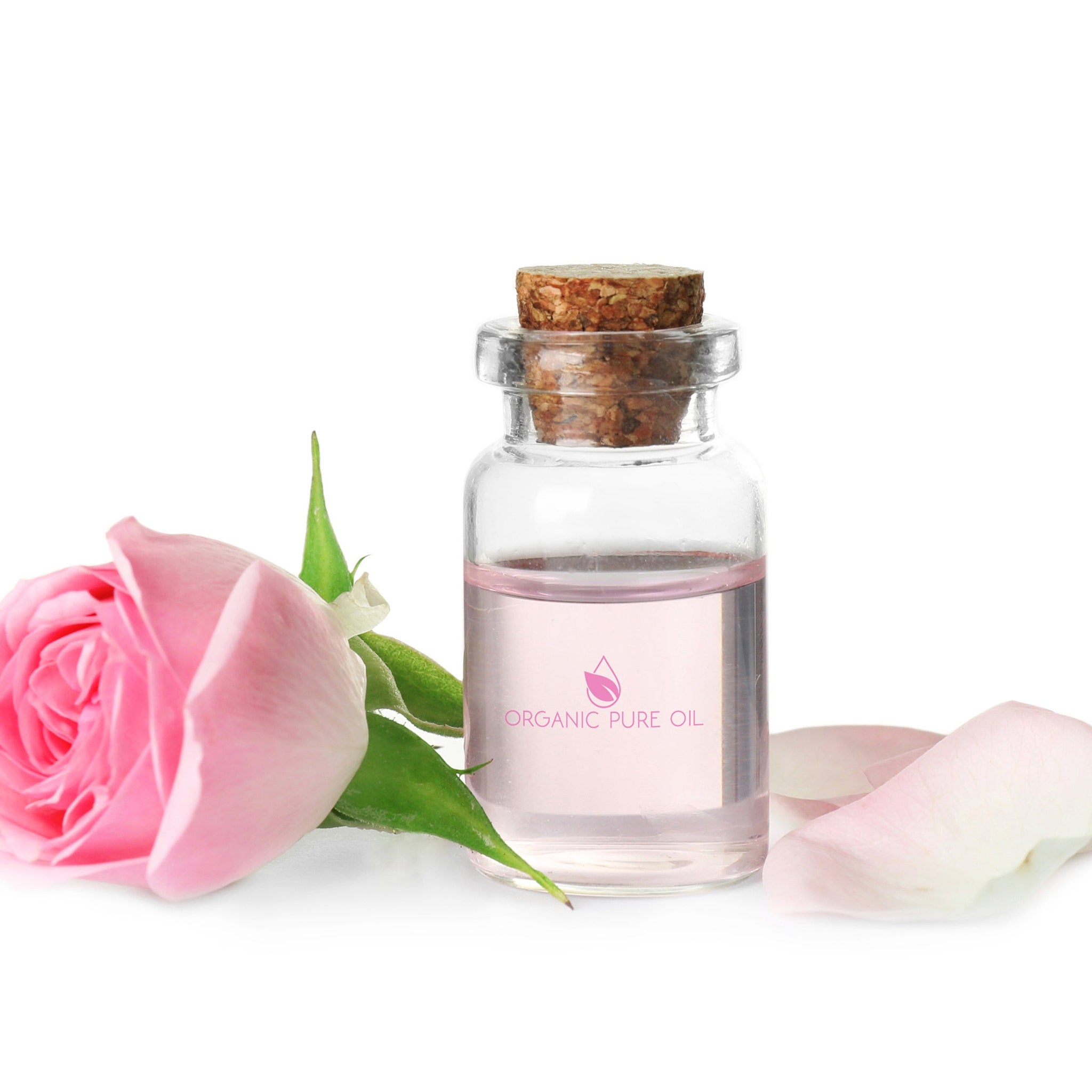 Rose oil bottle with cork, pink liquid, and pink rose petals on white background