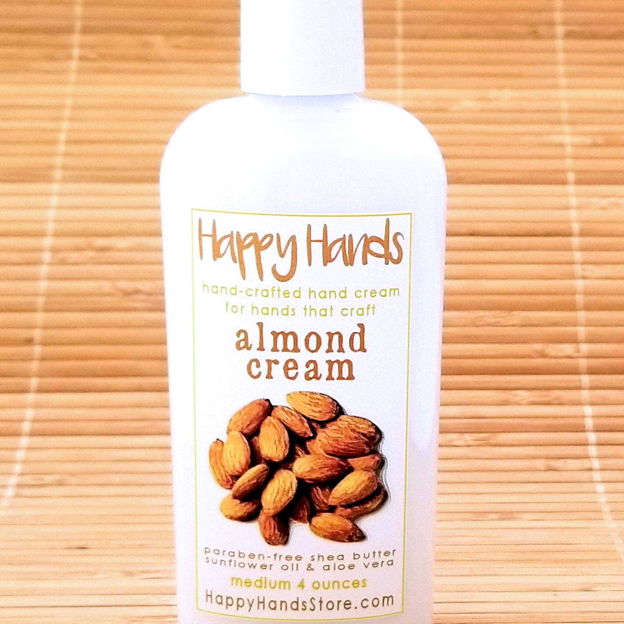 Close-up of gender-neutral almond cream hand cream tube with minimalist beige packaging and matte finish