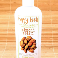 Hand applying almond-scented shea butter cream onto dry skin, showcasing rich texture and hydration