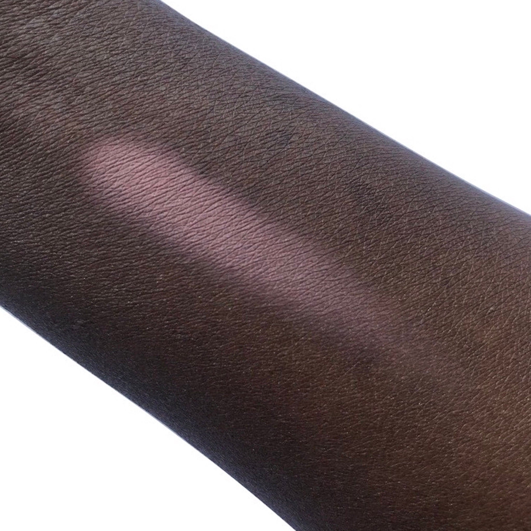 Skin swatch with dark brown skin and pink highlight, showing skin texture