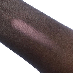 Skin swatch with dark brown skin and pink highlight, showing skin texture