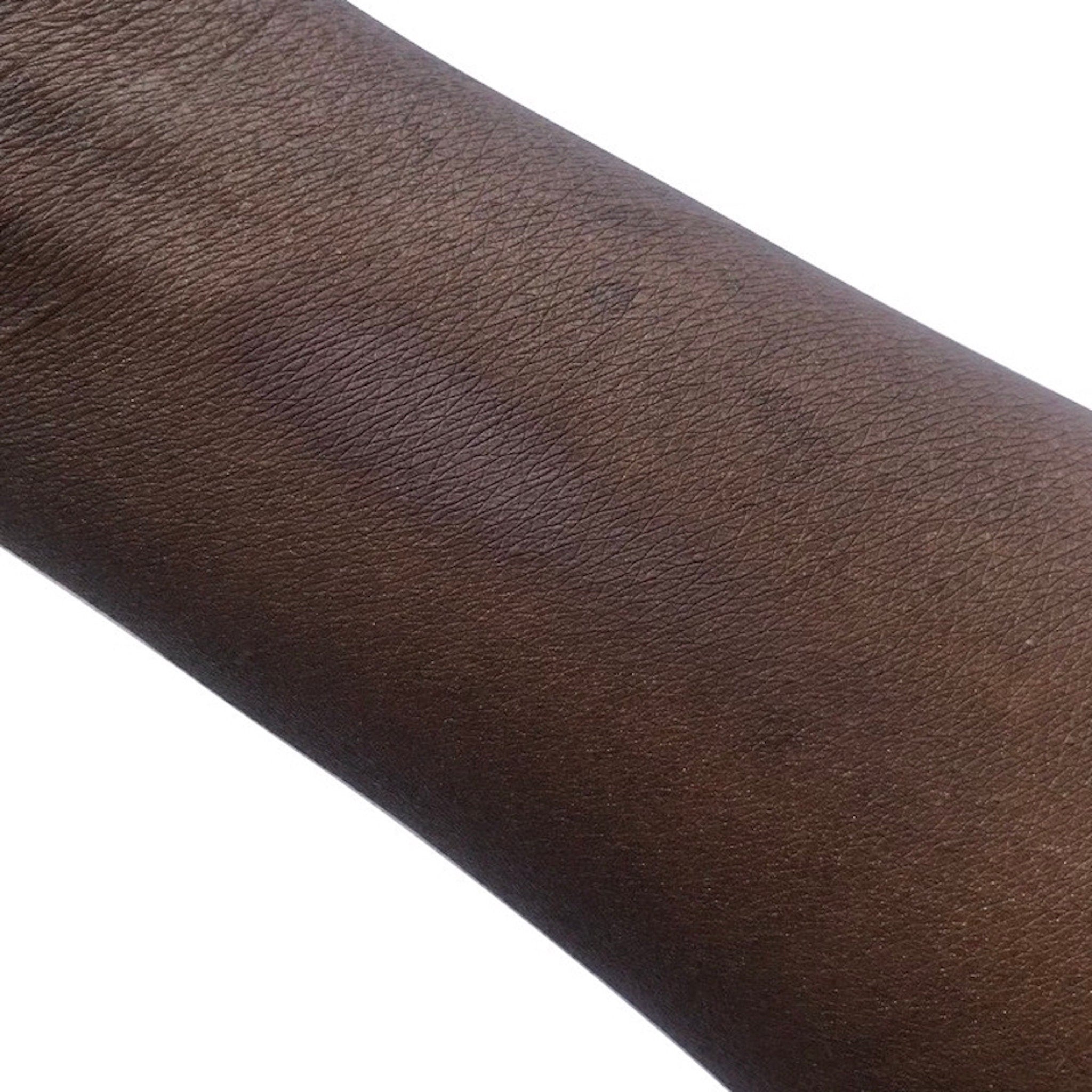 Dark brown skin texture with visible pores and fine lines detail on arm