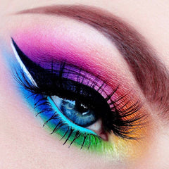 Eye makeup with rainbow eyeshadow, black eyeliner, and long black lashes on blue eye